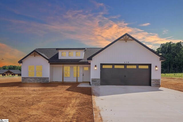103 Leon Dr, Anderson, SC 29621 - modern farmhouse style home with stone siding, concrete driveway, a garage, and a shingled roof