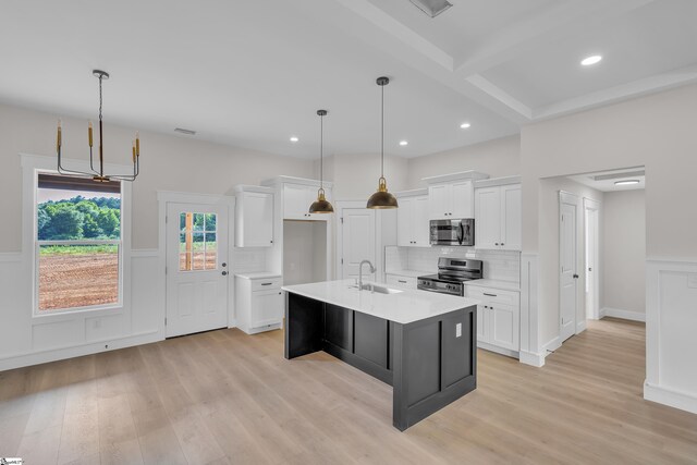 103 Leon Dr, Anderson, SC 29621 - kitchen with stainless steel appliances, a sink, light wood finished floors, light countertops, and white cabinetry