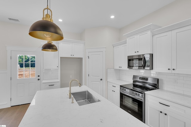 103 Leon Dr, Anderson, SC 29621 - kitchen featuring stainless steel appliances, a sink, light stone counters, white cabinets, and recessed lighting