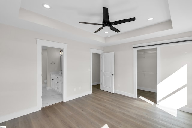103 Leon Dr, Anderson, SC 29621 - unfurnished bedroom with a tray ceiling, recessed lighting, baseboards, a closet, and light wood finished floors