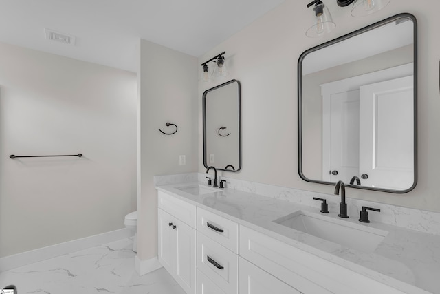 bathroom featuring toilet and vanity