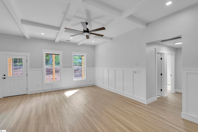 empty room with light hardwood / wood-style flooring, beam ceiling, ceiling fan, and a wealth of natural light