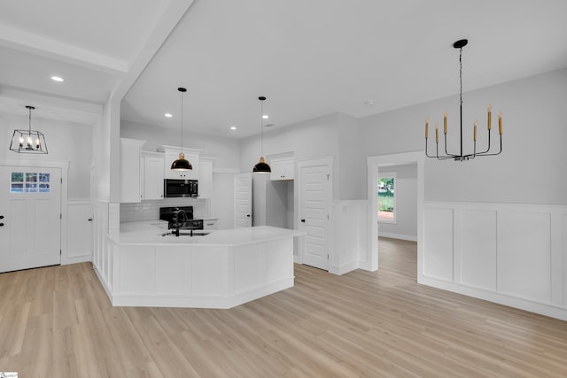 kitchen with tasteful backsplash, light hardwood / wood-style floors, kitchen peninsula, sink, and white cabinetry