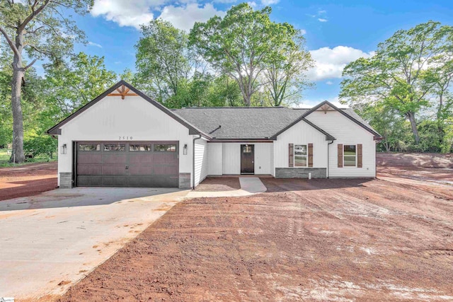 modern inspired farmhouse with a garage