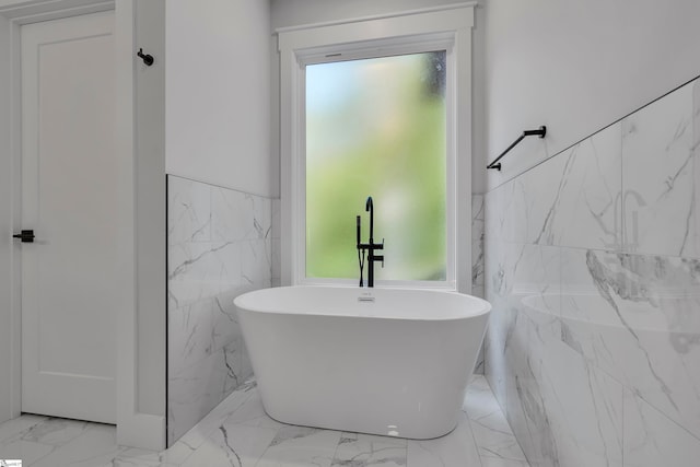 bathroom featuring a washtub and a healthy amount of sunlight