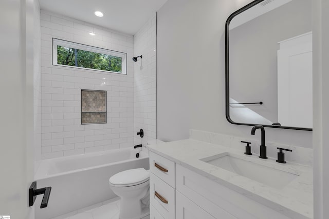 full bathroom with tiled shower / bath combo, vanity, and toilet