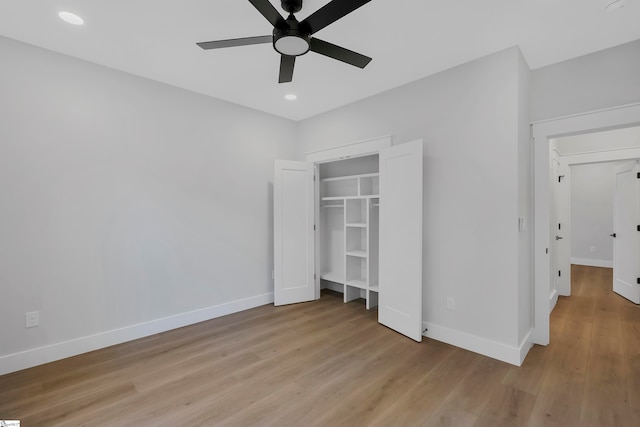 unfurnished bedroom with light hardwood / wood-style flooring, ceiling fan, and a closet