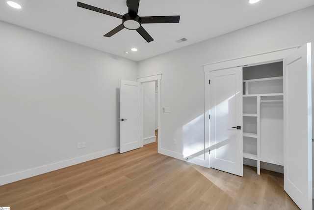 unfurnished bedroom featuring light wood-type flooring, ceiling fan, and a closet