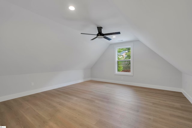 additional living space featuring lofted ceiling, light hardwood / wood-style flooring, and ceiling fan