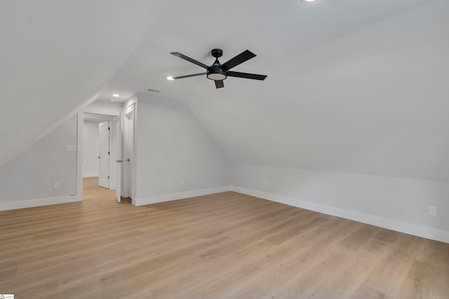 additional living space featuring light wood-type flooring, ceiling fan, and vaulted ceiling