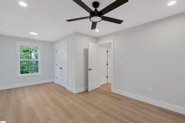 unfurnished bedroom with light hardwood / wood-style flooring and ceiling fan