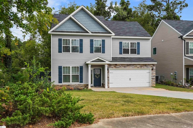 craftsman house featuring a garage and a front lawn