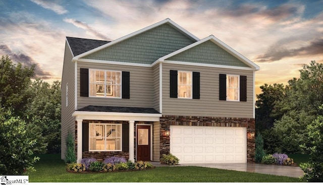 craftsman-style house featuring a garage and a lawn