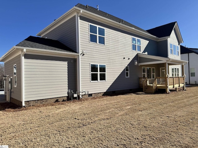 rear view of property featuring crawl space