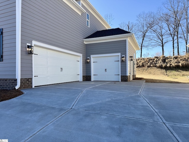 view of side of property featuring concrete driveway