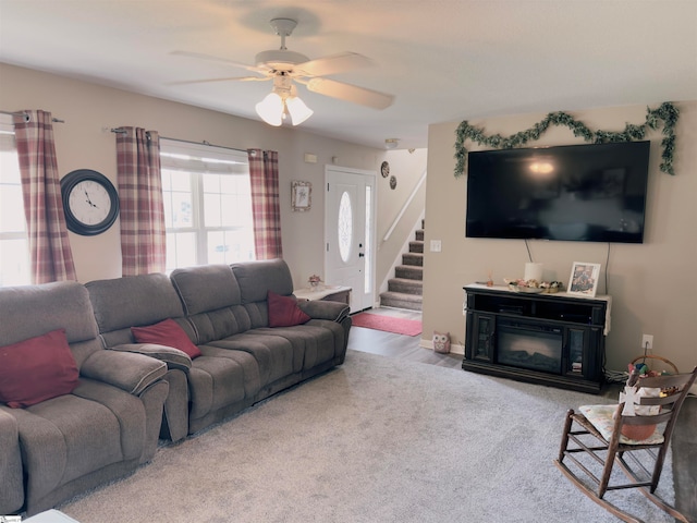 living room featuring carpet flooring and ceiling fan