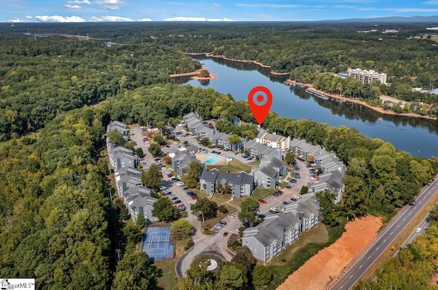 aerial view featuring a residential view, a water view, and a view of trees