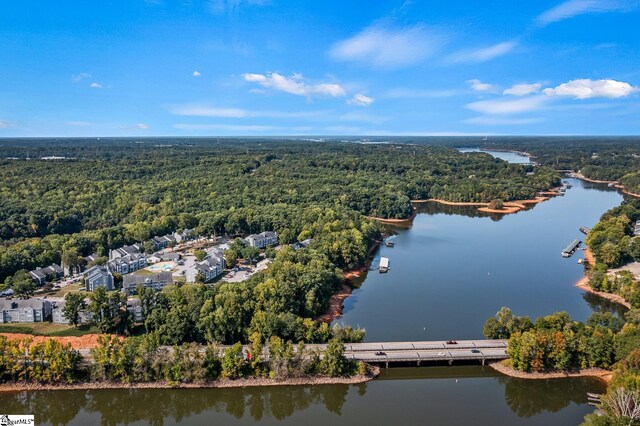 aerial view featuring a water view and a wooded view