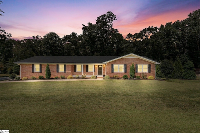 ranch-style home featuring a yard