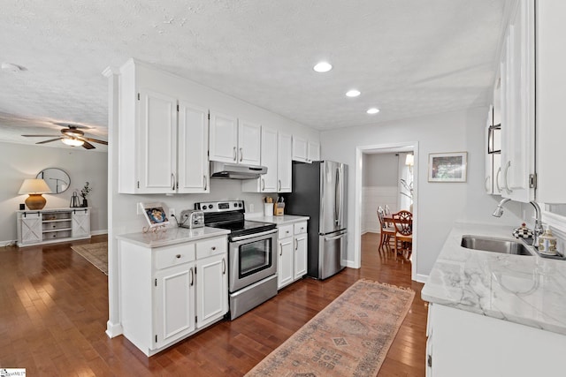 kitchen with appliances with stainless steel finishes, sink, ceiling fan, and dark wood-type flooring