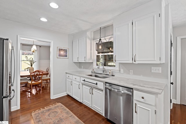 kitchen featuring white cabinets, dark hardwood / wood-style flooring, stainless steel appliances, and sink