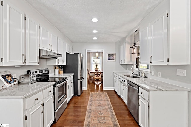 kitchen with plenty of natural light, stainless steel appliances, sink, and white cabinetry