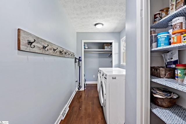 clothes washing area with dark hardwood / wood-style floors, a textured ceiling, and separate washer and dryer