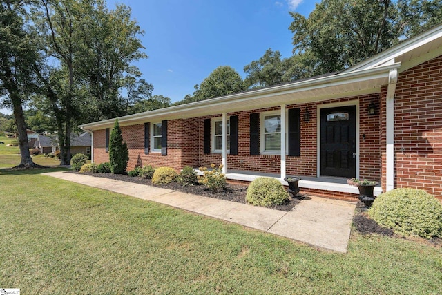 single story home featuring covered porch and a front lawn