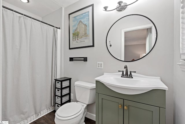 bathroom with vanity, toilet, and wood-type flooring