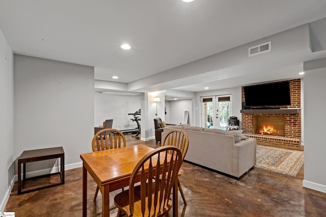 dining room with a fireplace and french doors