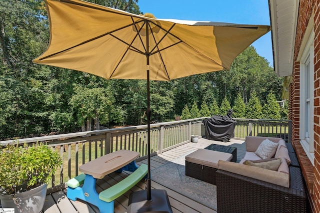 wooden terrace with area for grilling and an outdoor hangout area