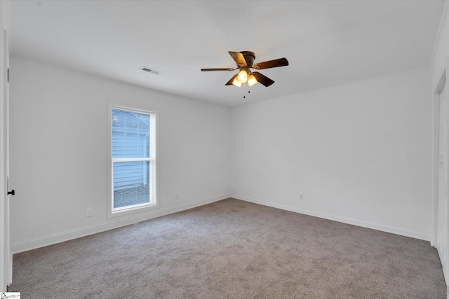 carpeted empty room featuring ceiling fan