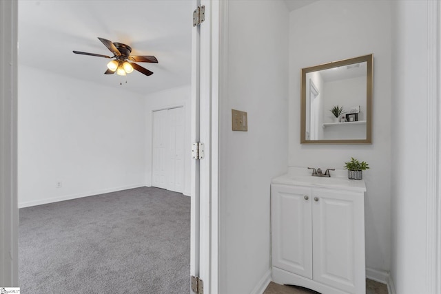 hallway featuring light carpet and sink