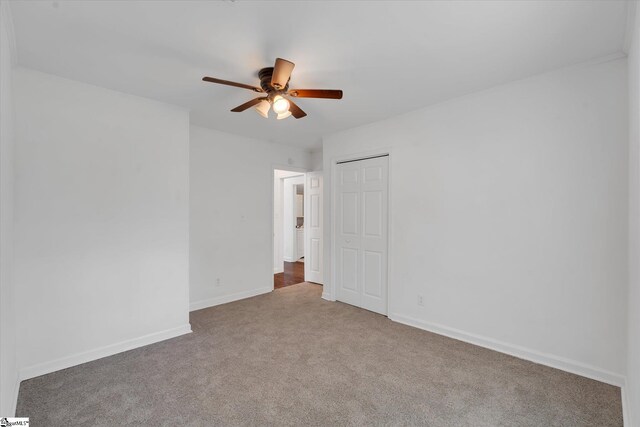 carpeted empty room with ceiling fan