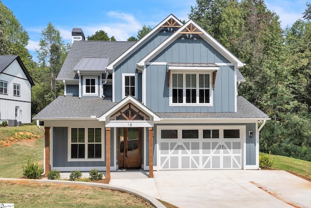 view of front of home with a garage, a front lawn, and cooling unit