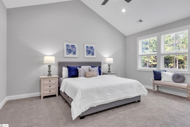 carpeted bedroom with ceiling fan and high vaulted ceiling