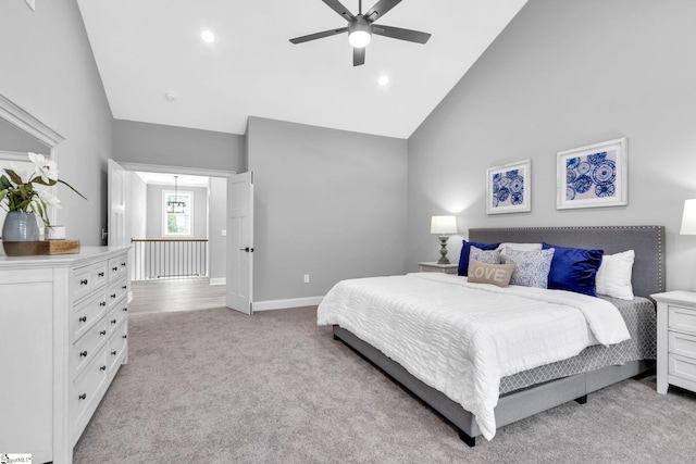 bedroom with high vaulted ceiling, ceiling fan, and light carpet