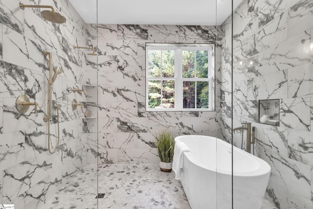 bathroom featuring plus walk in shower and tile walls