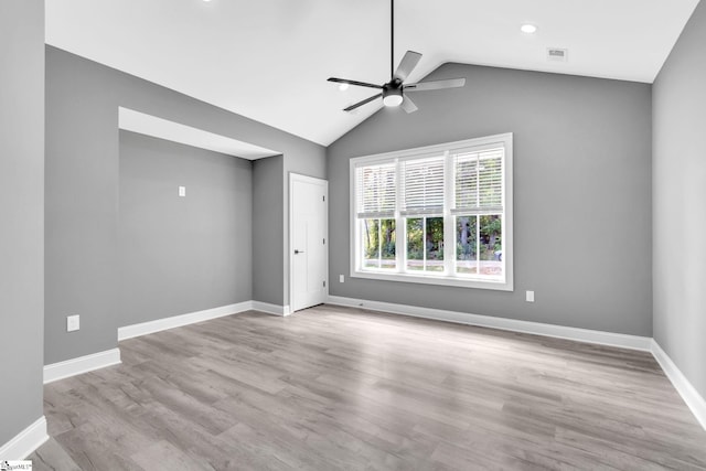 spare room with lofted ceiling, ceiling fan, and light hardwood / wood-style floors