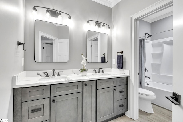 full bathroom featuring toilet, ornamental molding, vanity, shower / bathtub combination with curtain, and wood-type flooring