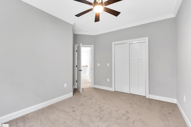 unfurnished bedroom featuring ceiling fan, light carpet, and ornamental molding