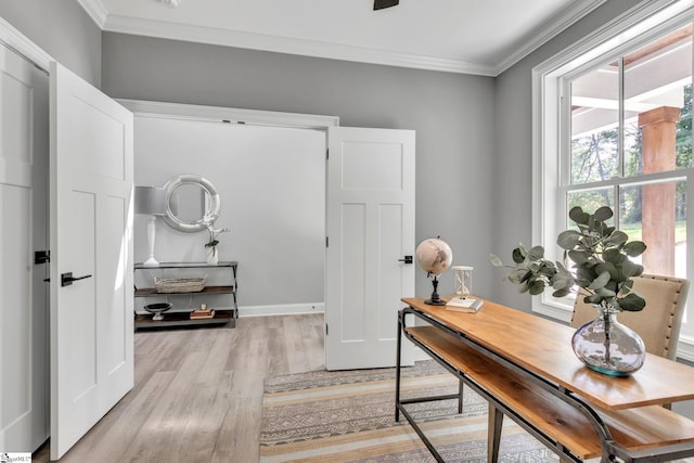 office area with light hardwood / wood-style floors and ornamental molding