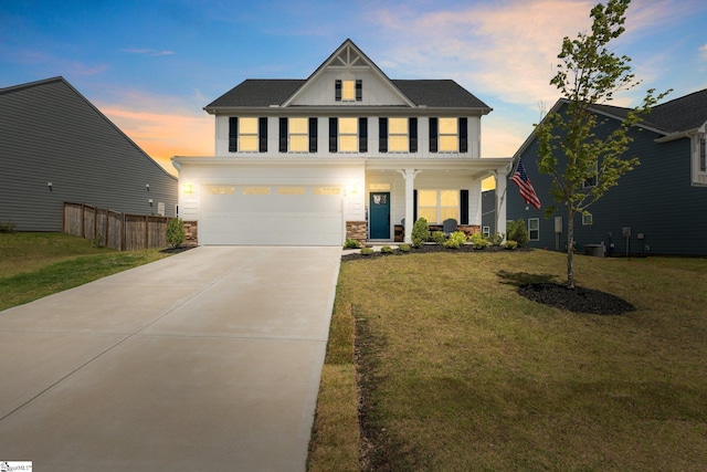 view of front facade with a yard, a garage, and a porch