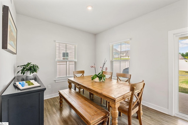 dining area featuring dark hardwood / wood-style floors and a healthy amount of sunlight