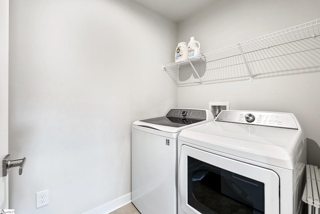 clothes washing area featuring washer and dryer