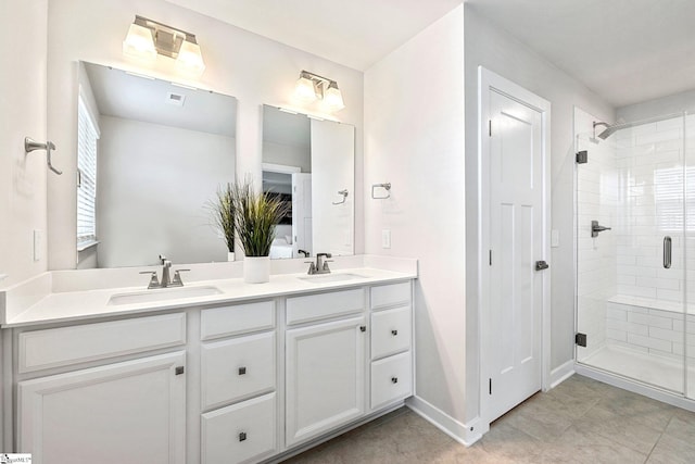 bathroom featuring a shower with shower door and vanity