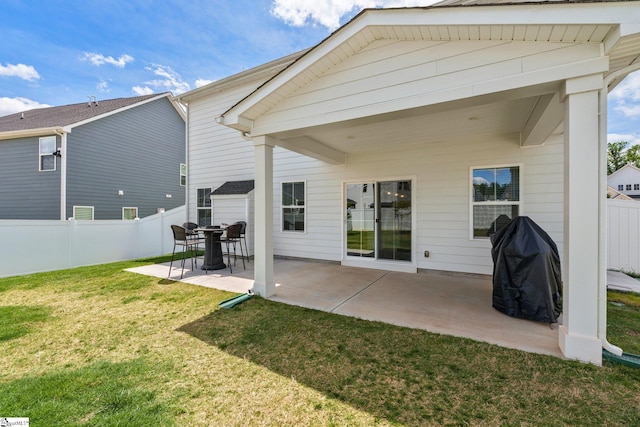 back of property featuring a yard and a patio