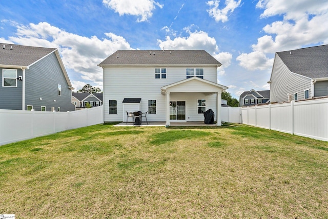 back of property featuring a yard and a patio