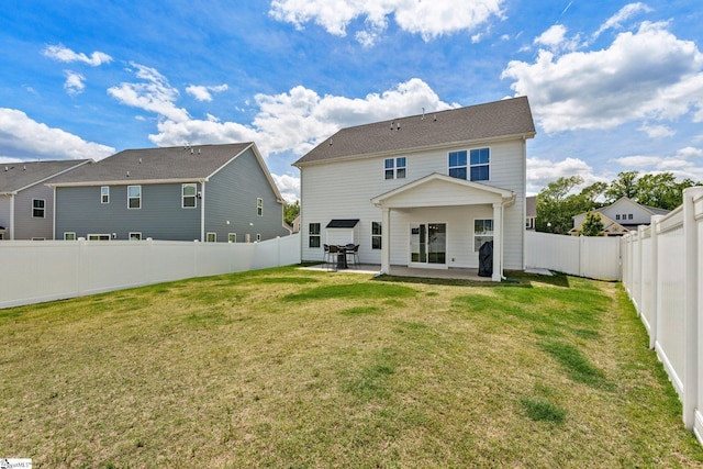 back of house featuring a yard and a patio area