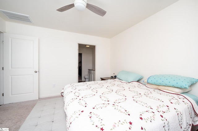 bedroom with lofted ceiling, ceiling fan, connected bathroom, and light carpet